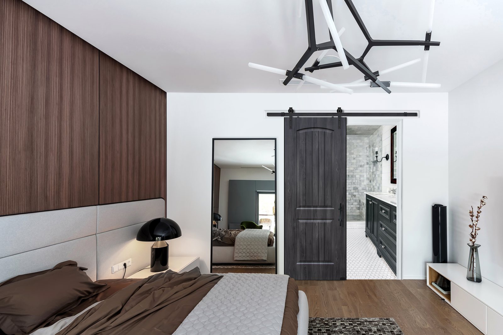 A Solid 2 Panel MDF barn door with an arched top panel, painted a dark color, on a black rail between a bedroom and a bathroom